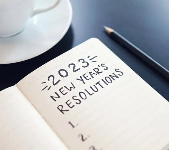 A notepad on a desk with a list titled '2023' with items being ticked off