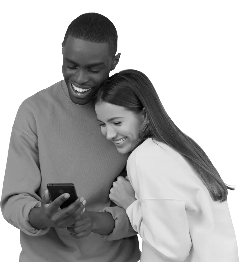 A man and woman both looking at a mobile phone and smiling