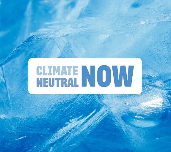 A Climate Neutral Now logo on a background image of an iceberg