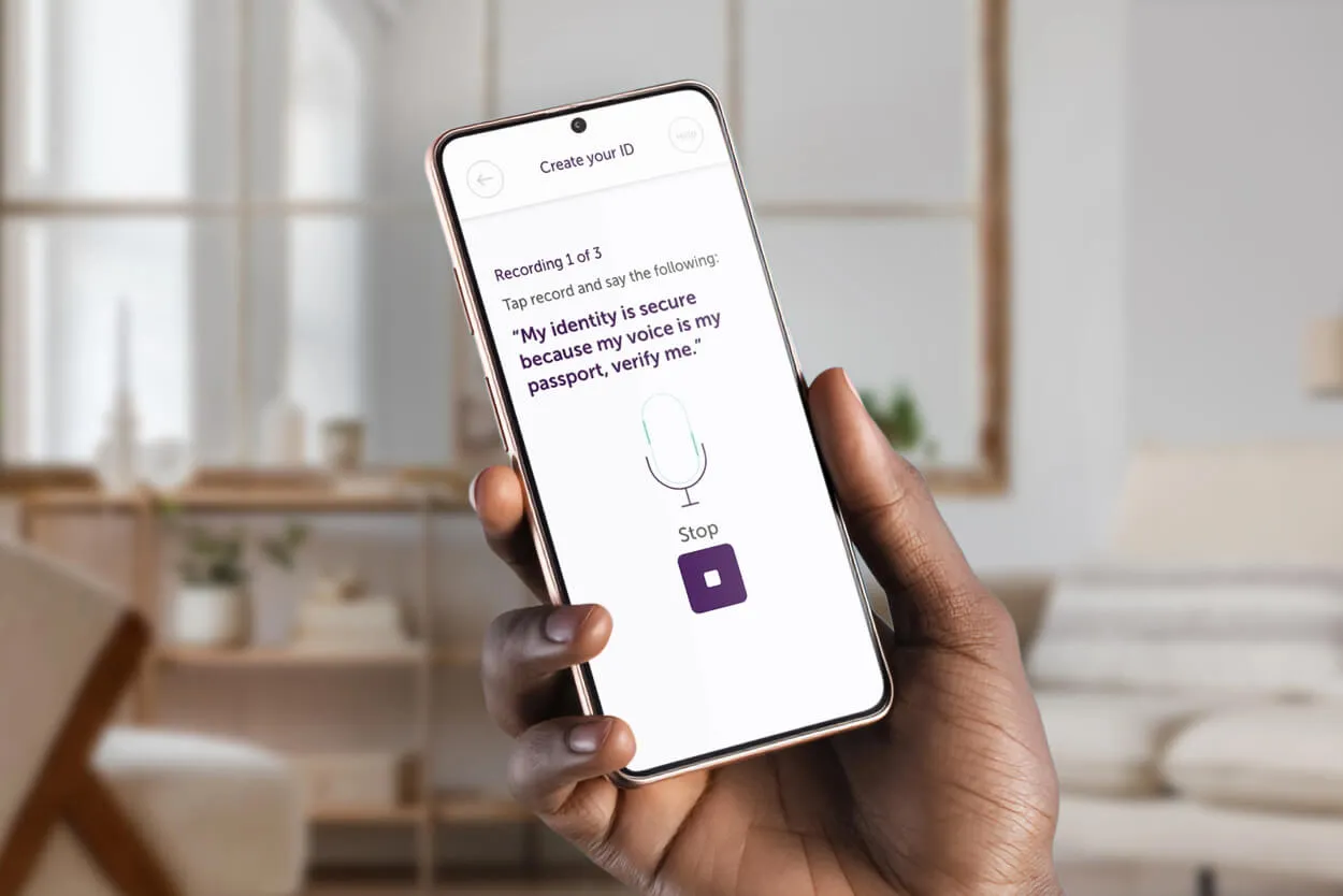A hand holding a phone that displays the create id page on the Atom Bank app
