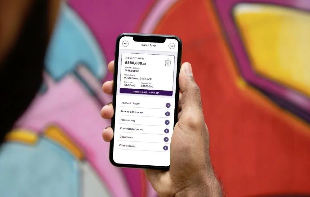 A hand holding a phone with instant saver on it