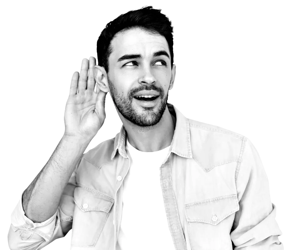 A man holding his hand up to his ear listening