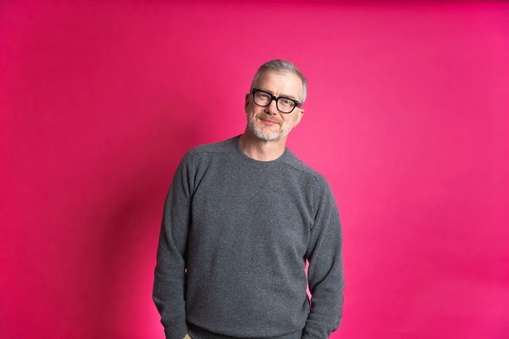 A picture of Mark Mullen with a pink background
