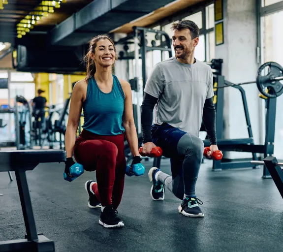 woman and man working out in the gym