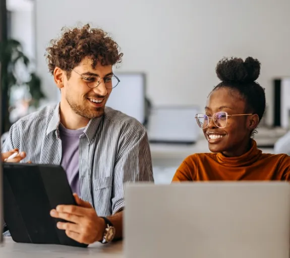 man and woman working on laptops