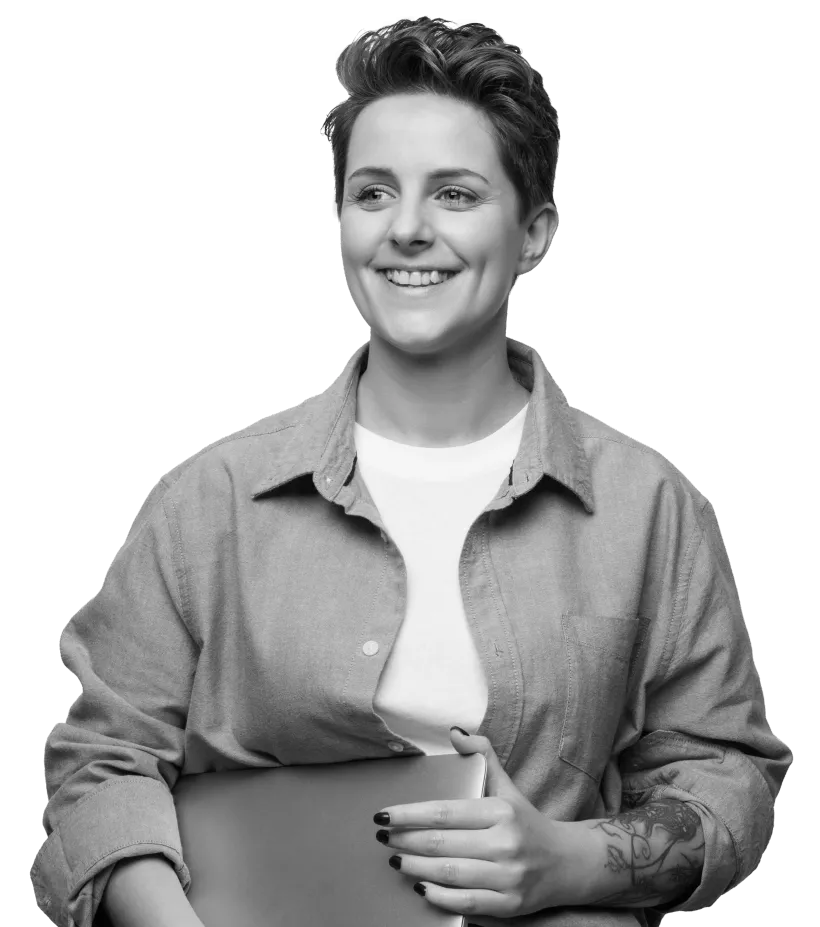 A woman holding her laptop and smiling