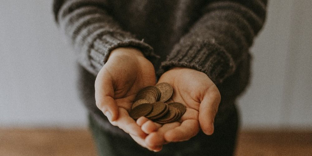 Child holding coins in their hands