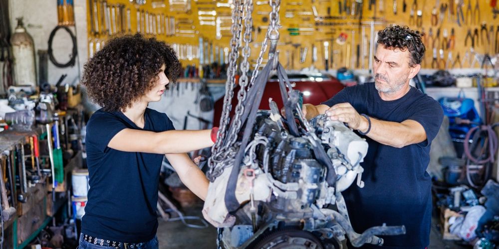 two mechanics working at a business 