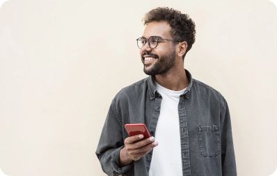 Person smiling away from their phone