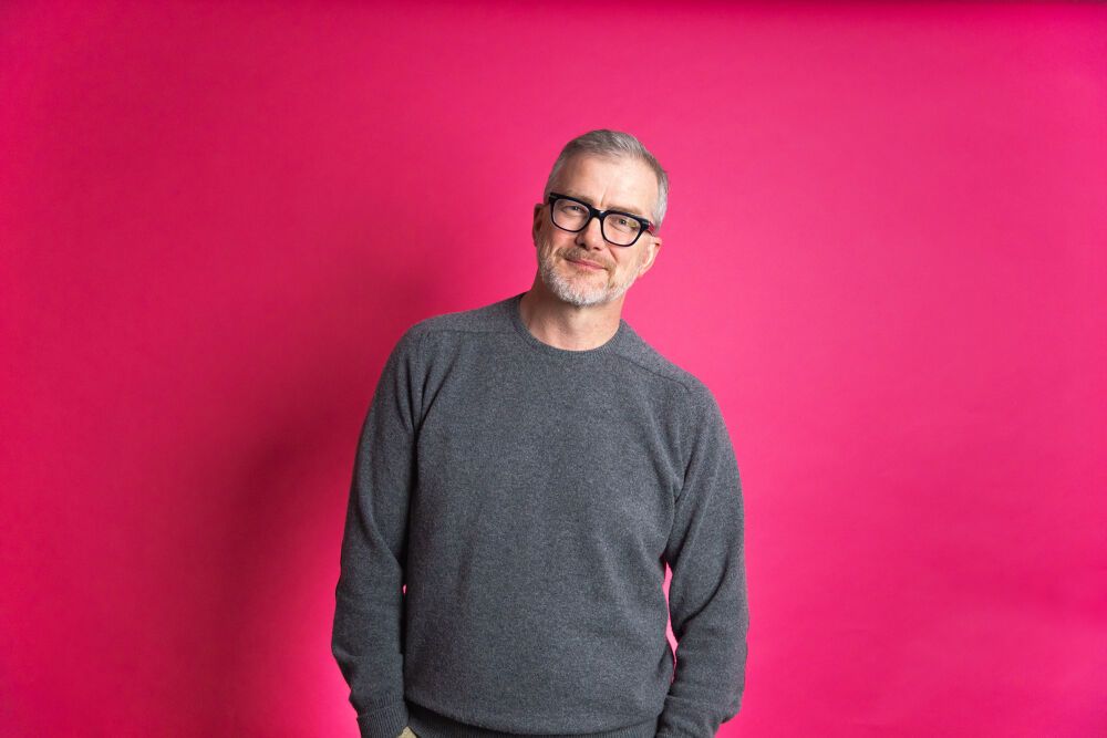 mark mullen with a pink background