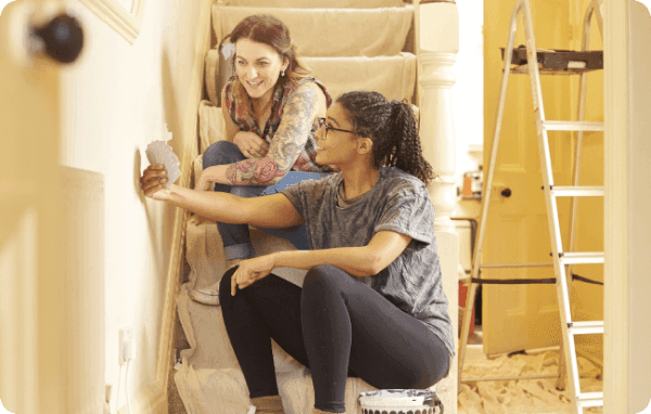 Two people scanning colour samples as they decorate a home