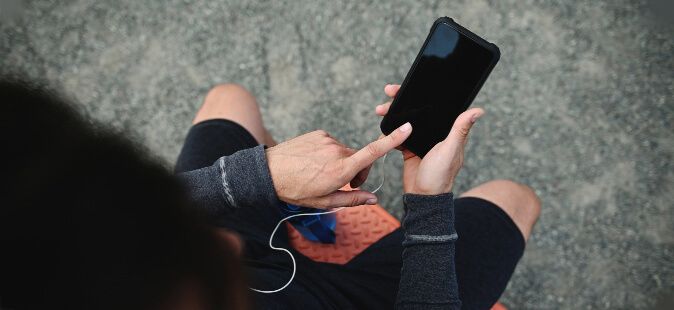 Person exercising is taking a break to look at their phone