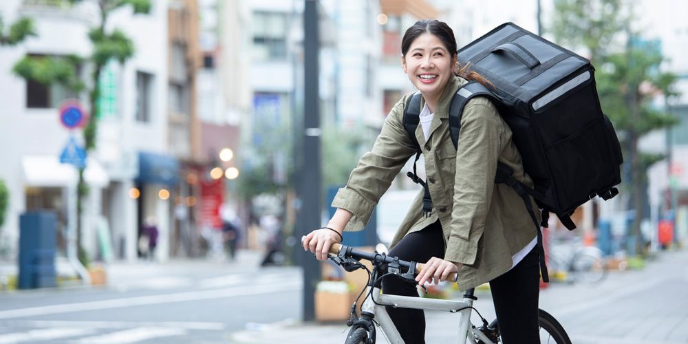 Woman riding bike and making deliveries