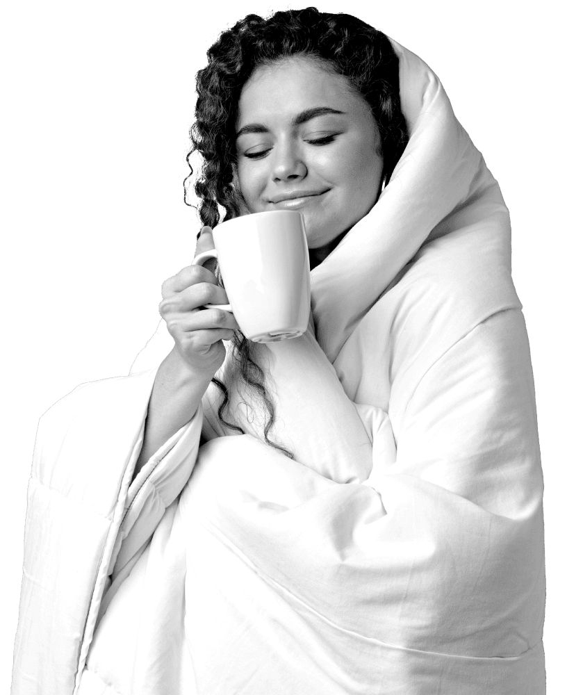 A woman wrapped in a blanket holding a cup