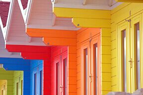 Rainbow beach huts all in a line