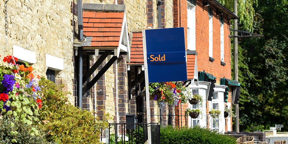 Sold sign outside terraced house