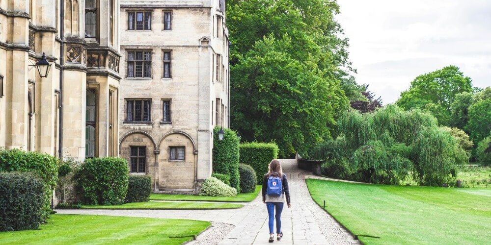 Student walking up path to university building