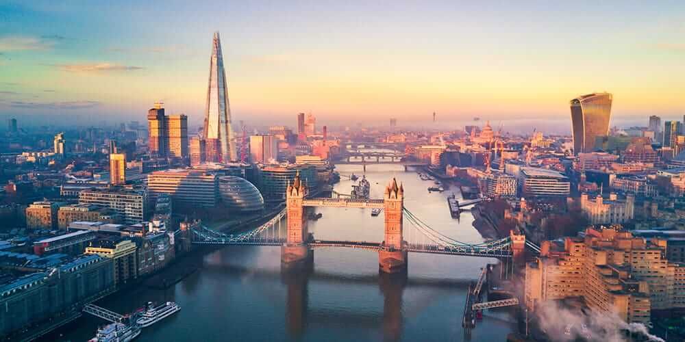 London skyline looking down the Thames over Tower Bridge at sunset