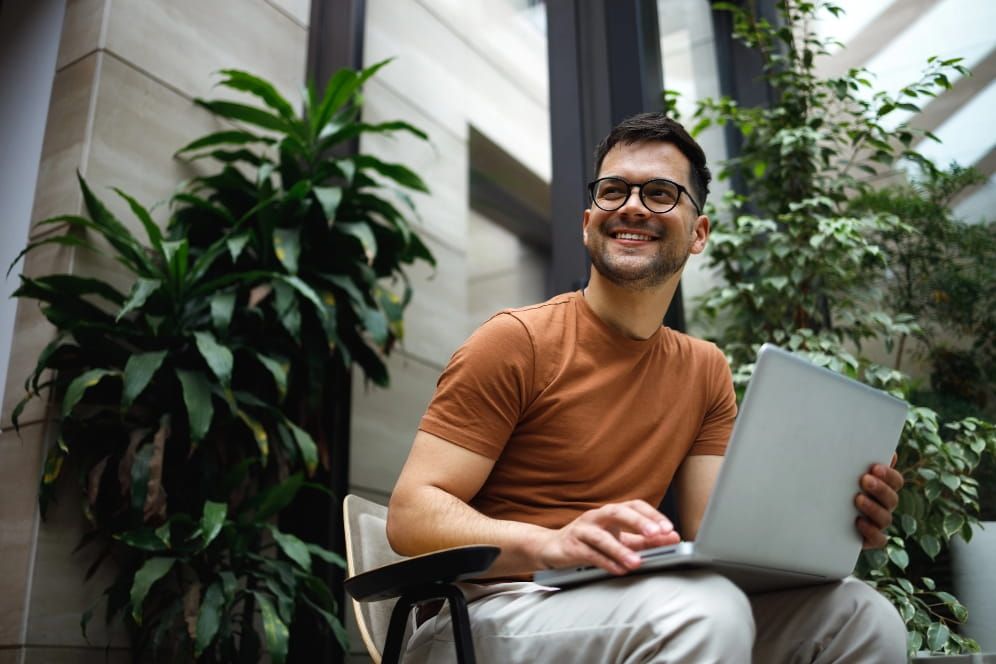 Person smiling away from their laptop